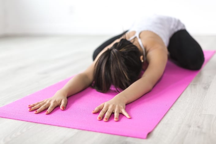 moan in child pose on yoga mat