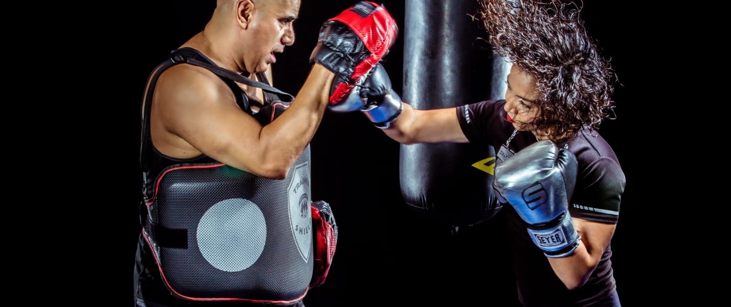 woman punching man in boxing gear