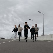 Triangle of people running along a street