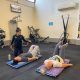 female trainer with two mone doing exercises on the floor