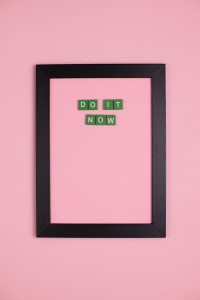 pink wall with black frame saying do it now
