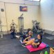two women doing core exercises with a personal trainer