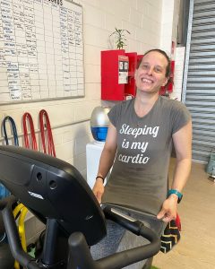 woman holding shirt that says "sleeping is my cardio"