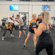 paris of women and men in a group fitness boxing class