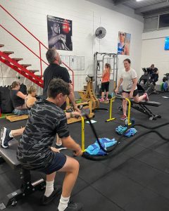 people in a gym on equipment working out