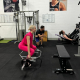 two women using weights while personal trainer supervises