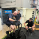 two men working out with a personal trainer supervisor