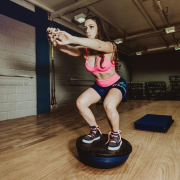 woman balancing on a bosu ball
