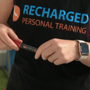 woman in recharged personal training singlet using insulin pen.