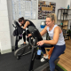 two women on the exercise bikes at a small gym