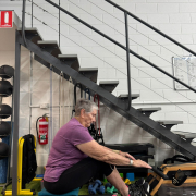 older woman working out on the rowing machine.