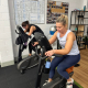two women on exercise bikes at a gym